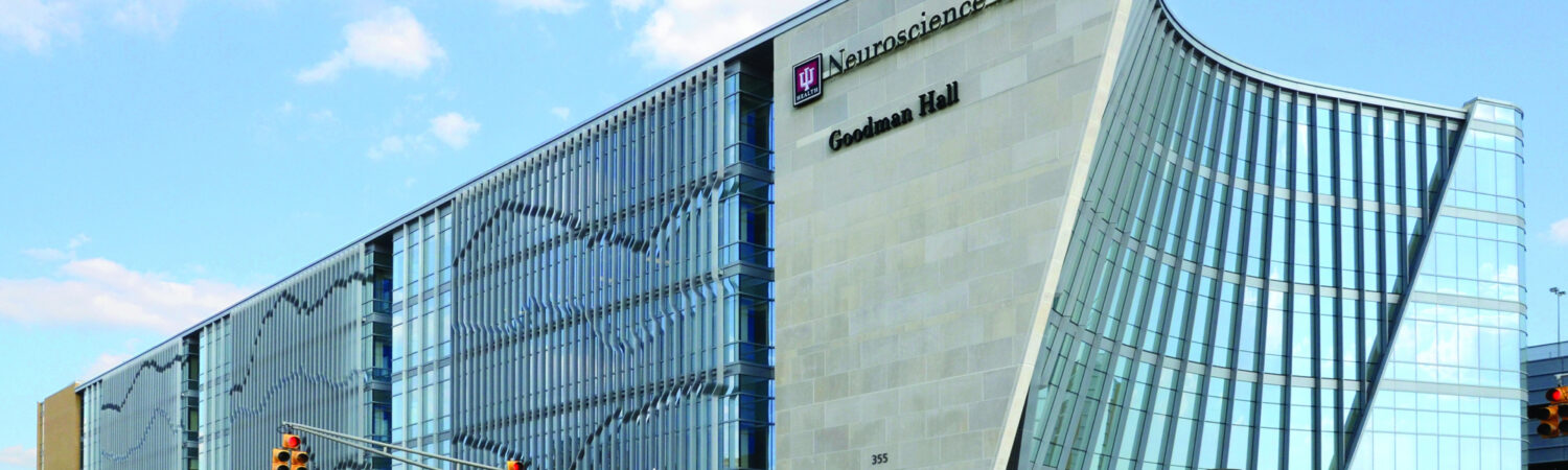 IU Health Neuroscience Center Goodman Hall building exterior at a city intersection.