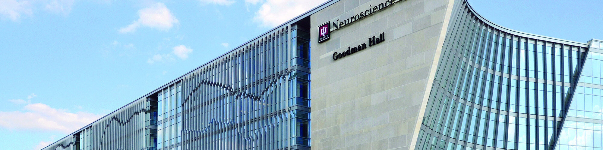IU Health Neuroscience Center Goodman Hall building exterior at a city intersection.