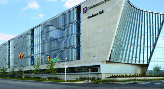 IU Health Neuroscience Center Goodman Hall building exterior at a city intersection.