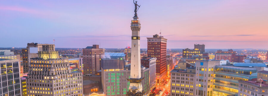 Indianapolis skyline at dusk with the Soldiers and Sailors Monument in downtown traffic circle.