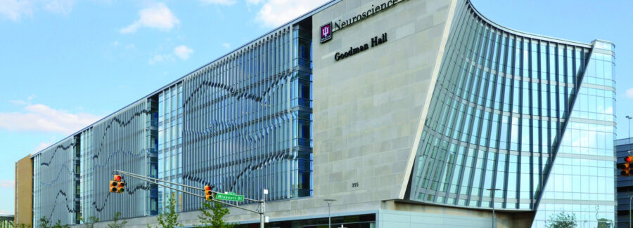 IU Health Neuroscience Center Goodman Hall building exterior at a city intersection.