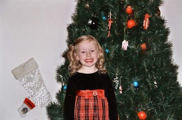 Emma Wicker by Christmas tree