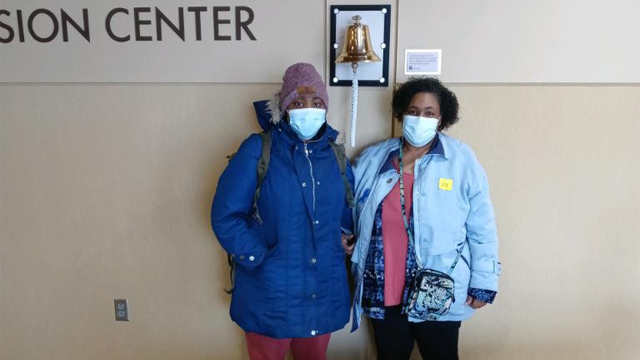 Individuals pose in front of IU Health's Infusion Center