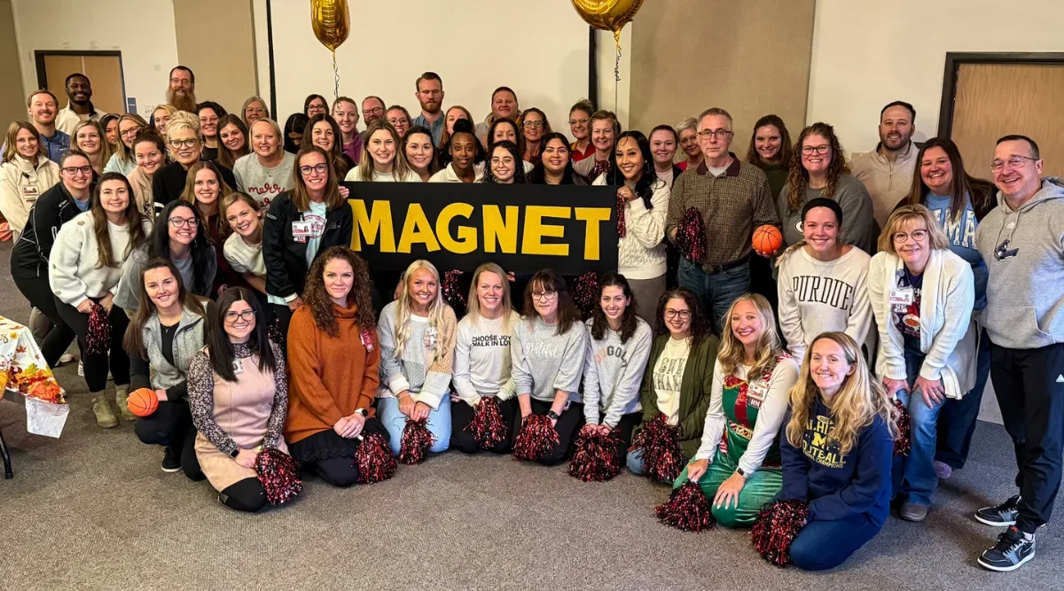 group posing with sign