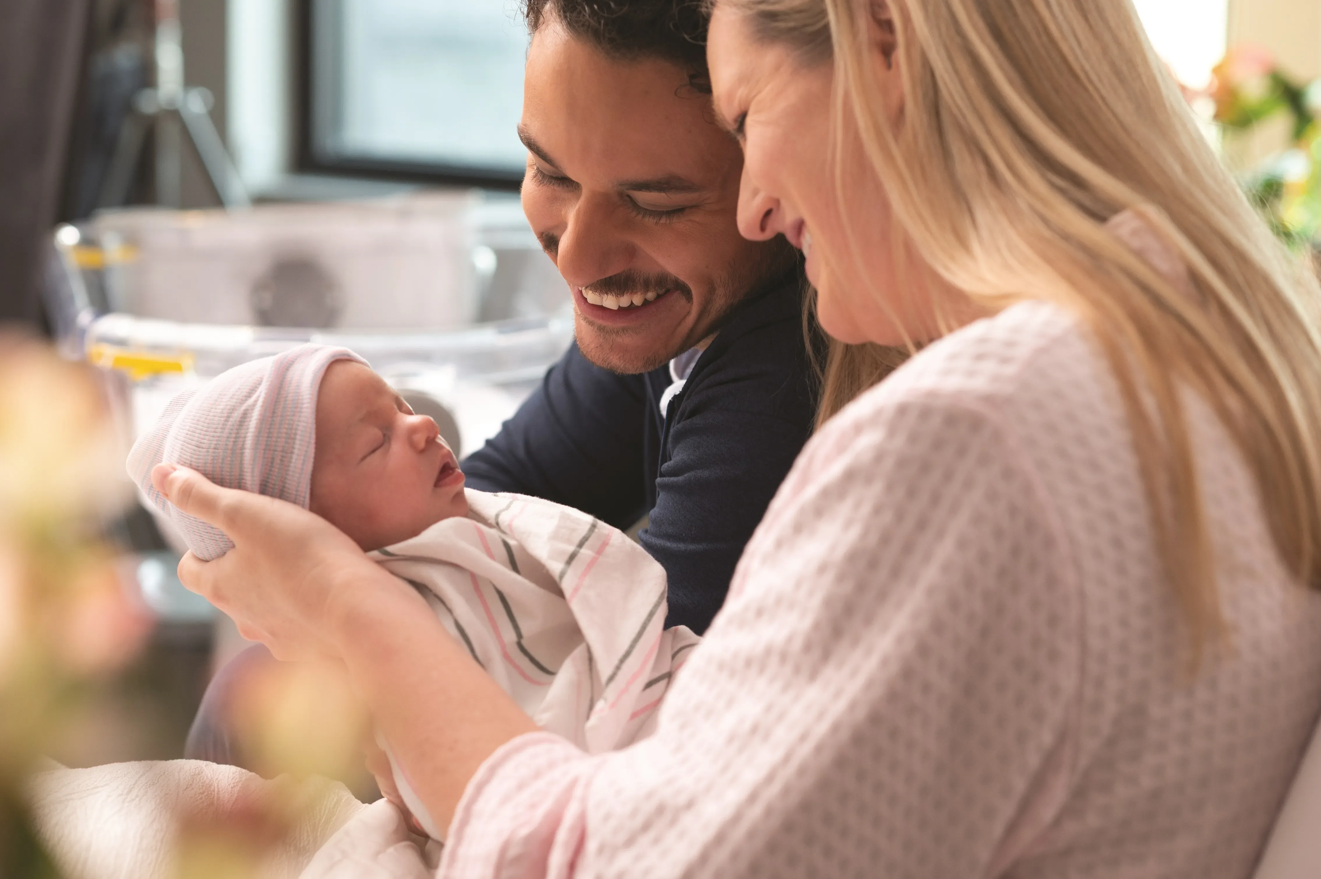 Parents holding new baby