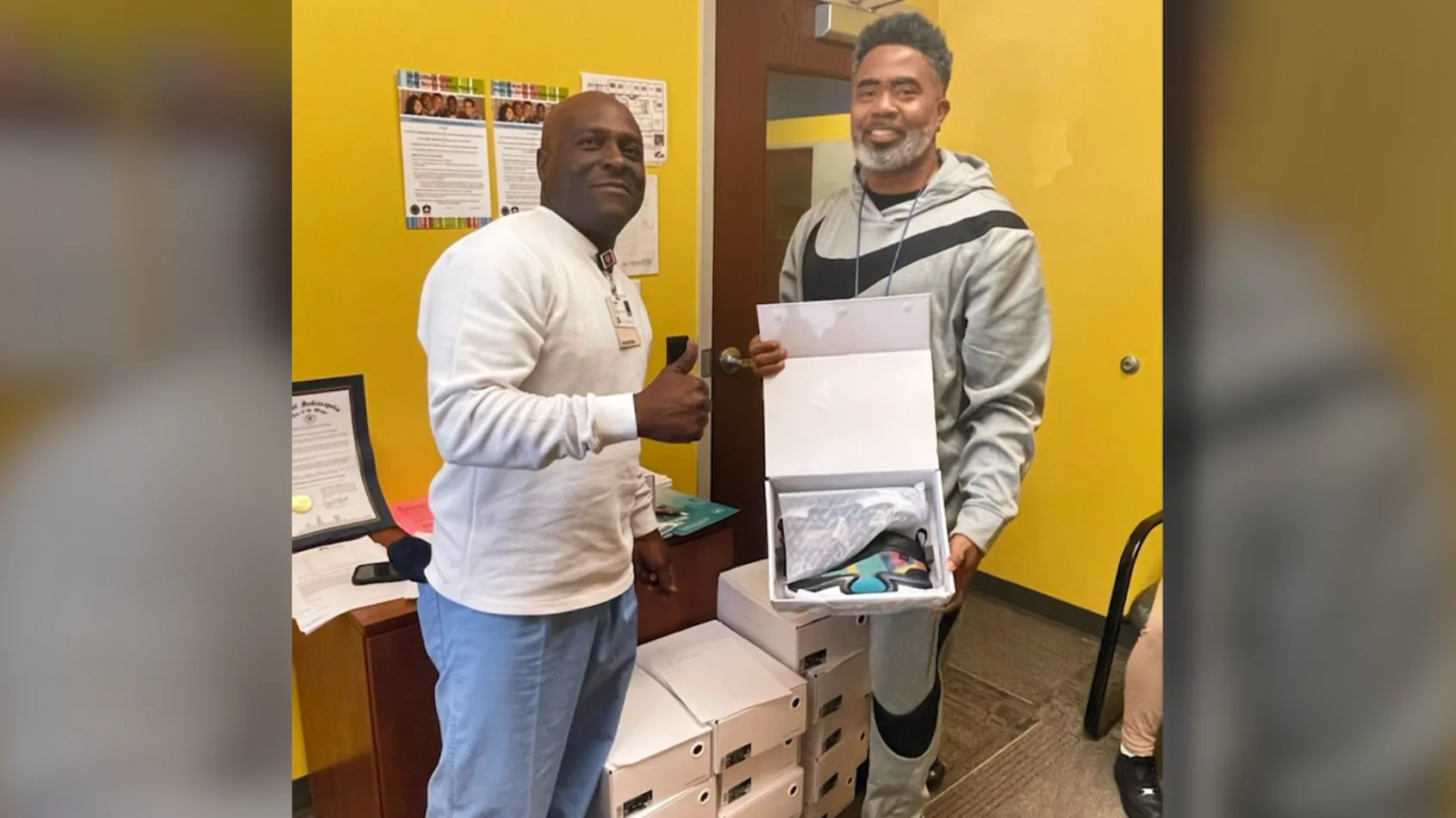 Team members donate shoes to basketball team