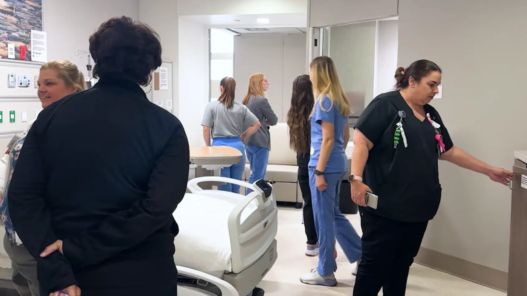 Team members move through mockup of new hospital space