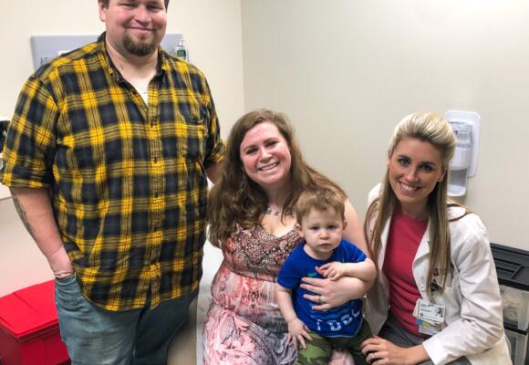 Resident working with family on delivery of number two